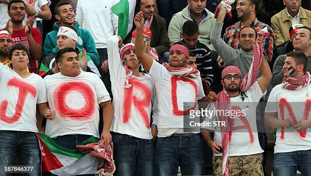 Jordanese fans cheer on their national team before their FIFA 2014 World Cup qualifier football match against Uruguay at the International Stadium on...