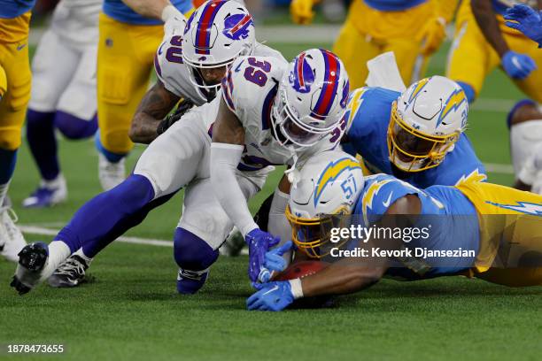 Cam Lewis of the Buffalo Bills and Amen Ogbongbemiga of the Los Angeles Chargers dive for a loose ball in the first quarter at SoFi Stadium on...