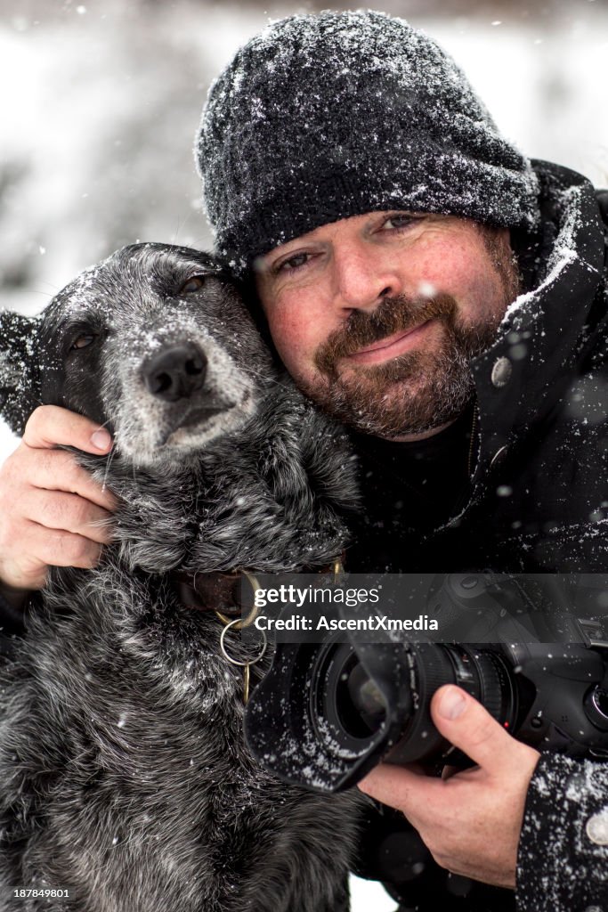 Portrait of photographer and dog in snowstorm