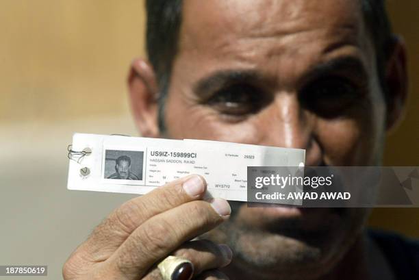 Released Iraqi prisoner shows his picture ID come wrist band after being released from the Abu Ghraib prison, some 30 kms west of Baghdad 06 June...