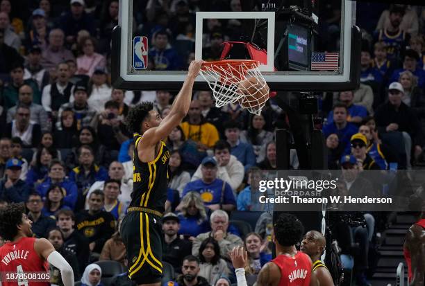 Trayce Jackson-Davis of the Golden State Warriors slam dunks in the first half against the Portland Trail Blazers at Chase Center on December 23,...