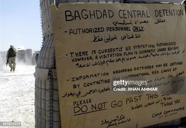 Soldier walks towards the entrance of the Abu Ghraib prison, 15 kilometers west of Baghdad, 01 August 2003. US troops have renovated the prison, the...