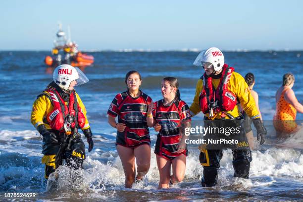 Daring participants are braving the icy waters of the North Sea during the Redcar Rotary Club Annual Boxing Day Dip in Redcar, United Kingdom, on...