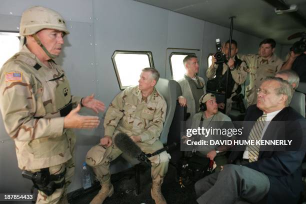 Secretary of Defense Donald Rumsfeld and Chairman of the Joint Chiefs of Staff Richard Myers are briefed by Major General Geoffrey Miller, the deputy...