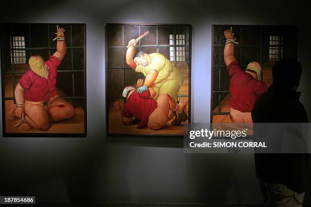 The paintings by Colombian artist Fernando Botero are displayed during the inauguration of his exhibition of 78 paintings on the Abu Ghraib prison in...