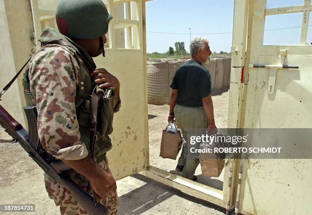 Former Iraqi prisoner of the Abu Ghraib prison walks away from the main gate at a local Iraqi Civil Defense Corps camp in the outskirts of Baghdad...