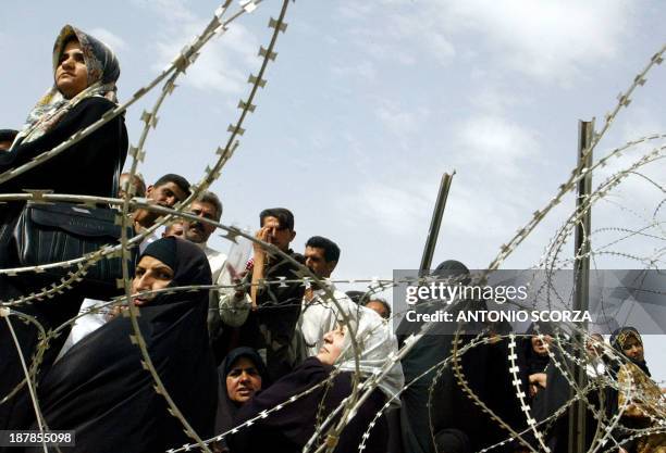 Iraqi women queue up as they wait at the entrance of the Abu Ghraib prison, 20 May 2004 in hope of getting information about their loved ones held by...