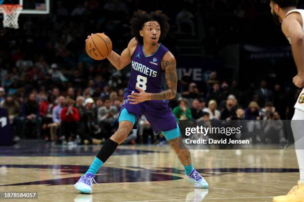 Nick Smith Jr. #8 of the Charlotte Hornets controls the ball during the first half of an NBA game against the Denver Nuggets at Spectrum Center on...