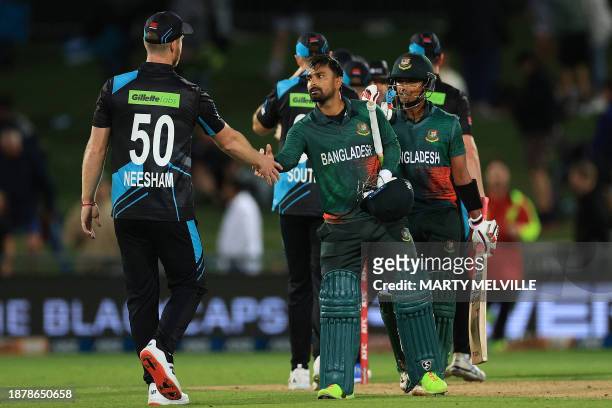Bangladesh's Litton Das shakes hands with New Zealand's James Neesham after Bangladesh's victory in the first Twenty20 cricket match between New...