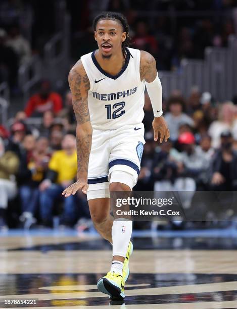 Ja Morant of the Memphis Grizzlies reacts after shooting over Trae Young of the Atlanta Hawks during the fourth quarter at State Farm Arena on...