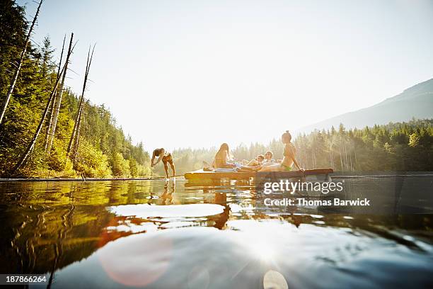 group of friends hanging out on floating dock - high diving platform stock pictures, royalty-free photos & images