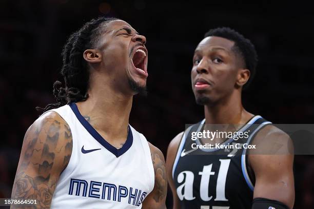 Ja Morant of the Memphis Grizzlies reacts after dunking against the Atlanta Hawks during the third quarter at State Farm Arena on December 23, 2023...