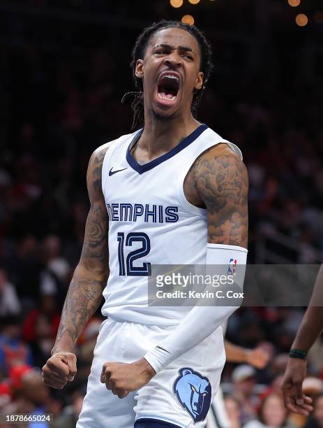 Ja Morant of the Memphis Grizzlies reacts after dunking against the Atlanta Hawks during the third quarter at State Farm Arena on December 23, 2023...