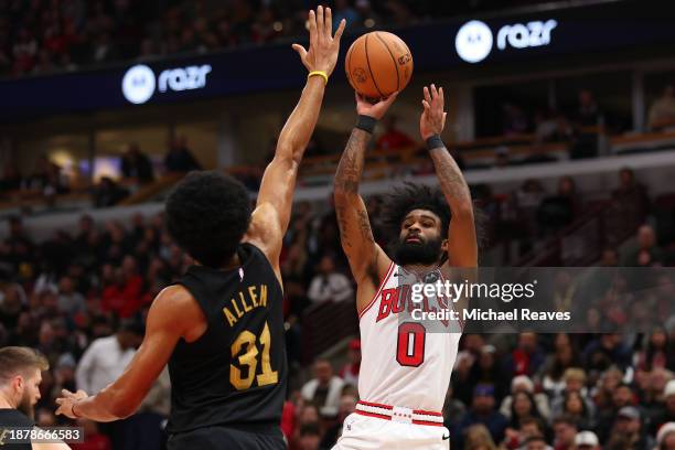 Coby White of the Chicago Bulls shoots over Jarrett Allen of the Cleveland Cavaliers during the second half at the United Center on December 23, 2023...