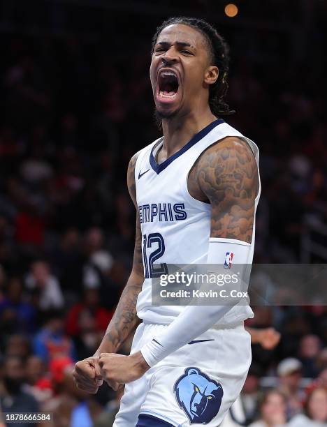 Ja Morant of the Memphis Grizzlies reacts after dunking against the Atlanta Hawks during the third quarter at State Farm Arena on December 23, 2023...