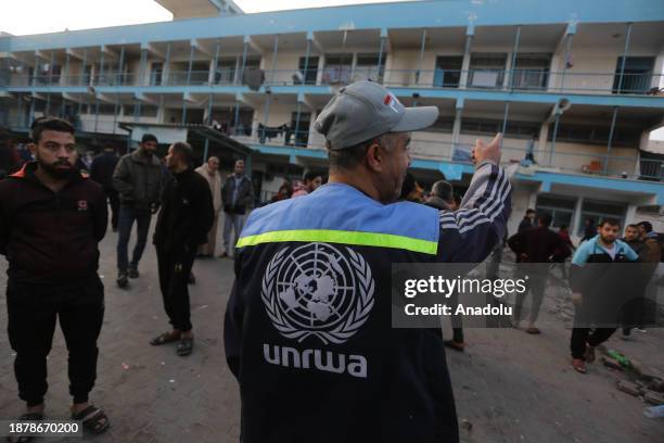 Palestinians gather their belongings and leave the area after Israeli airstrike hit Al-Maghazi School affiliated with UNRWA at Al-Maghazi refugee...