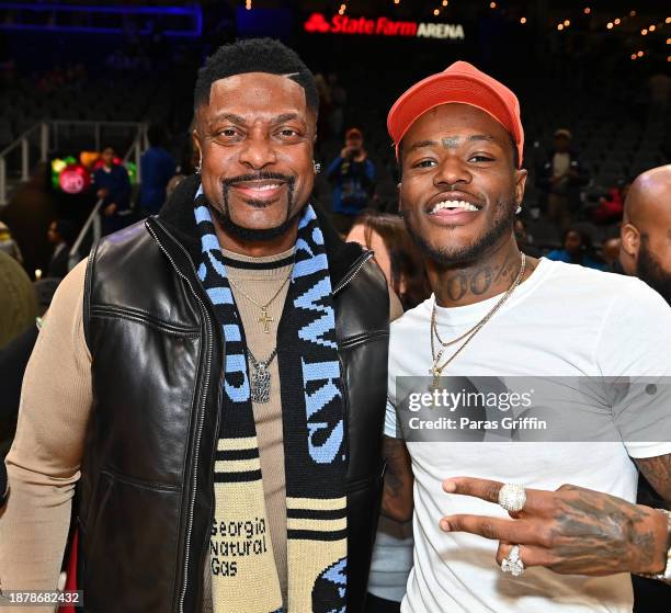 Comedians/actors Chris Tucker and D.C. Young Fly attend the game between Memphis Grizzlies and the Atlanta Hawks at State Farm Arena on December 23,...