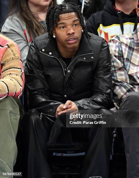 Rapper Lil Baby attends the game between Memphis Grizzlies and the Atlanta Hawks at State Farm Arena on December 23, 2023 in Atlanta, Georgia. NOTE...