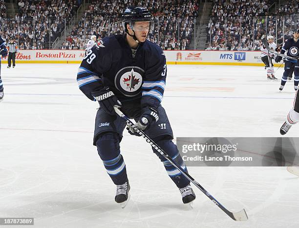 Tobias Enstrom of the Winnipeg Jets follows the play down the ice during third period action against the Chicago Blackhawks at the MTS Centre on...