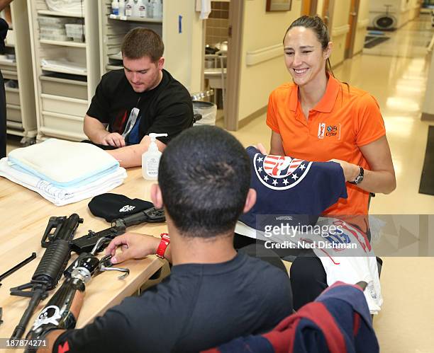 Ruth Riley of the Atlanta Dream greets a patient during a visit to Walter Reed Medical Center on November 12, 2013 in Bethesda, MD. NOTE TO USER:...