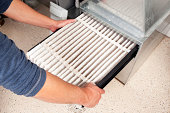 Hands Changing Furnace Air Filter
