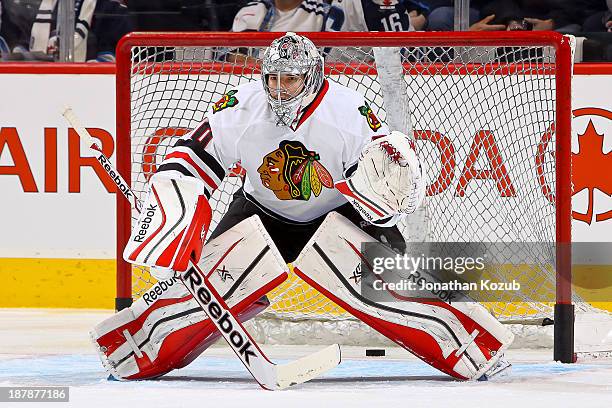 Goaltender Corey Crawford of the Chicago Blackhawks takes part in the pre-game warm up prior to NHL action against the Winnipeg Jets at the MTS...