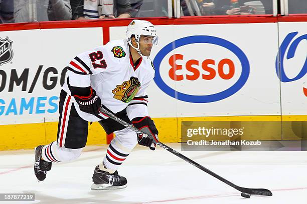 Johnny Oduya of the Chicago Blackhawks carries the puck up the ice during first period action against the Winnipeg Jets at the MTS Centre on November...