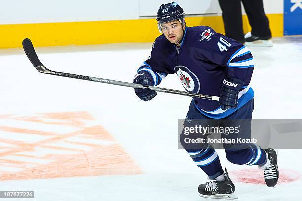 Devin Setoguchi of the Winnipeg Jets follows the play up the ice during first period action against the Chicago Blackhawks at the MTS Centre on...