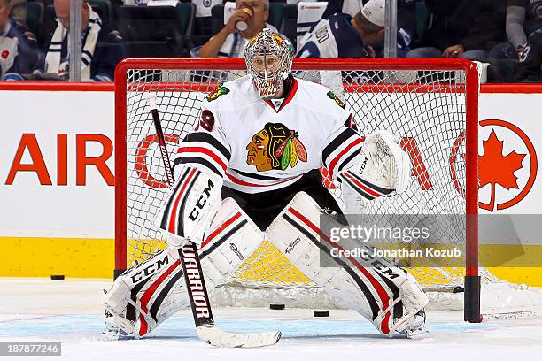 Goaltender Nikolai Khabibulin of the Chicago Blackhawks takes part in the pre-game warm up prior to NHL action against the Winnipeg Jets at the MTS...