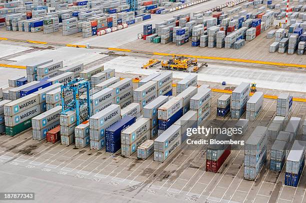 Shipping containers sit on the dockside at the Port of Rotterdam seen from the Maersk Mc-Kinney Moeller Triple-E Class ship, operated by A.P....