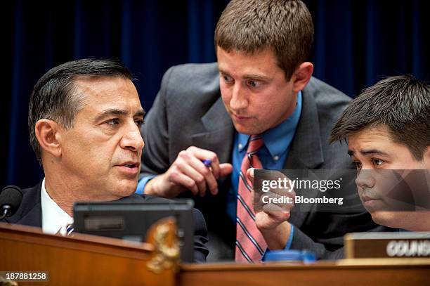 Representative Darrell Issa, a Republican from California, left, confers with staff members while he chairs a House Oversight and Government Reform...