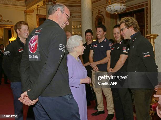 Britain's Queen Elizabeth II talks to Dominic West , Team Ambassador of Team Commonwealth, as Ed Parker , co-Founder of 'Walking with the Wounded'...