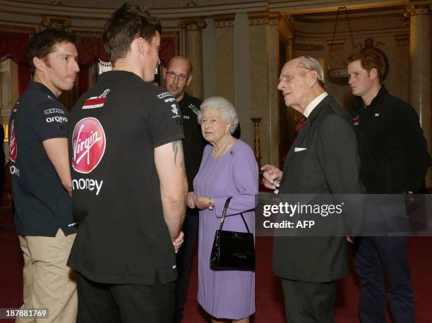 Britain's Queen Elizabeth II, her husband Prince Philip and Prince Harry are introduced to members of 'Team Commonwealth' during a reception at...