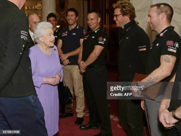 Britain's Queen Elizabeth II, meets members of Team Commonwealth during a reception at Buckingham Palace in London, on November 13 for the Queen and...