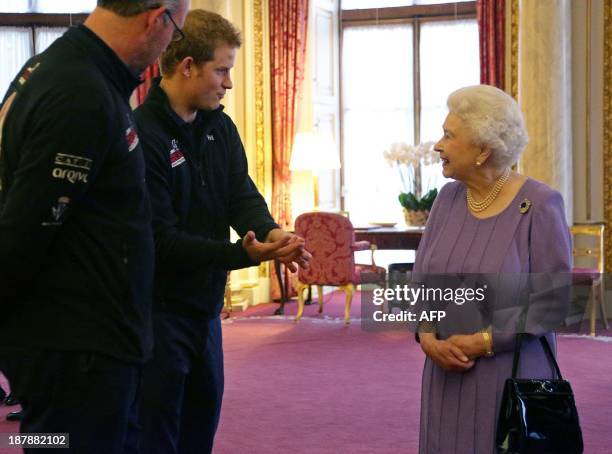 Britain's Queen Elizabeth II, speaks to her grandson Prince Harry during a reception at Buckingham Palace in London, on November 13 for the Queen and...