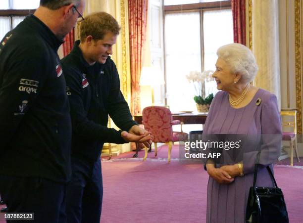Britain's Queen Elizabeth II, speaks to her grandson Prince Harry during a reception at Buckingham Palace in London, on November 13 for the Queen and...