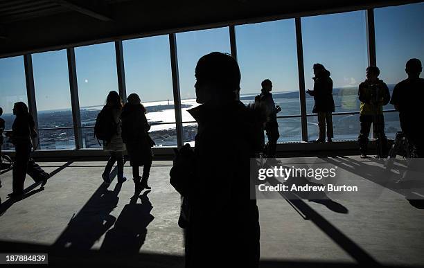 Members of the media walk around the 68th floor of Four World Trade Center after the opening ceremony for the building on November 13, 2013 in New...