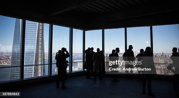 Members of the media walk around the 68th floor of Four World Trade Center after the opening ceremony for the building on November 13, 2013 in New...