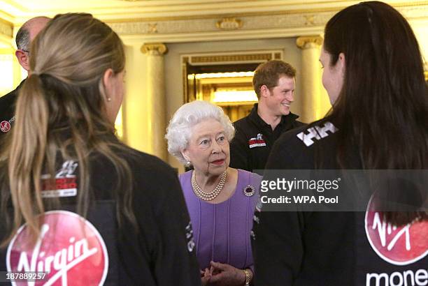Queen Elizabeth II and Prince Harry meet members of Team Commonwealth during a reception to meet the three teams of wounded servicemen and women from...