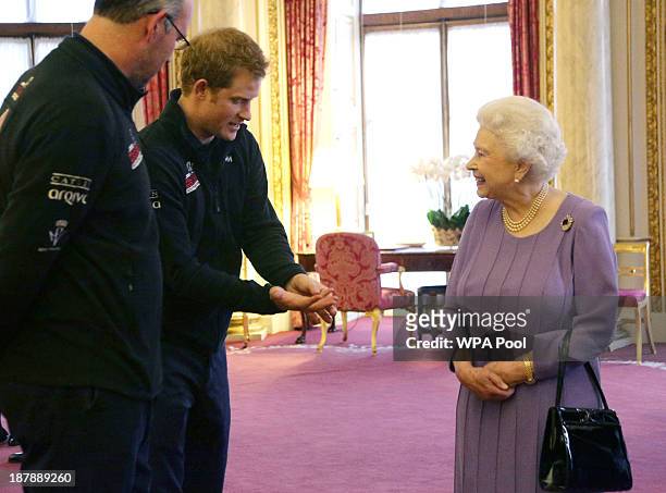 Prince Harry and Queen Elizabeth II in conversation, as Ed Parker , co-Founder of Walking with the Wounded and team mentor of Team USA looks on...