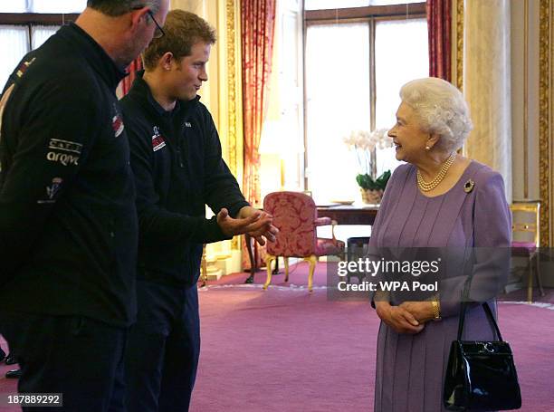 Prince Harry and Queen Elizabeth II in conversation, as Ed Parker , co-Founder of Walking with the Wounded and team mentor of Team USA looks on...