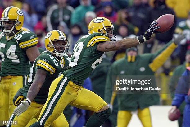 Special teams player Robert Ferguson of the Green Bay Packers and teammate Tony Fisher celebrate a fumble recovery on a punt against the Buffalo...