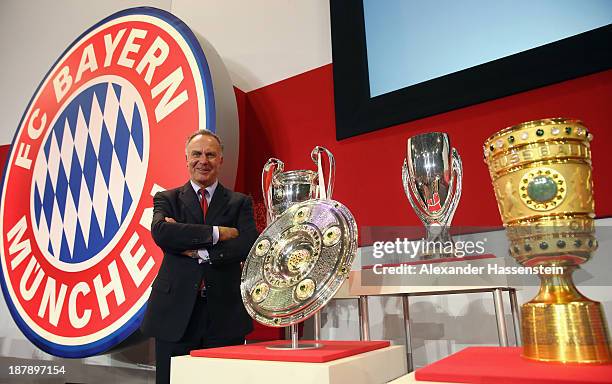 Karl-Heinz Rummenigge, CEO of FC Bayern Muenchen poses with the UEFA Champions League winners trophy , German League winners trophy , the UEFA Super...