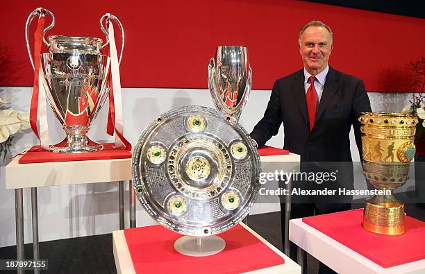 Karl-Heinz Rummenigge, CEO of FC Bayern Muenchen poses with the UEFA Champions League winners trophy , German League winners trophy , the UEFA Super...