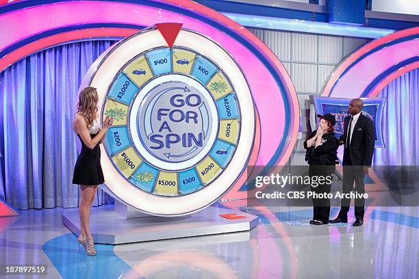 Model Danielle Demski claps as Kathleen Follweiler of Stuart, FL waits for the Go For a Spin wheel to stop while host Wayne Brady gives direction, on...