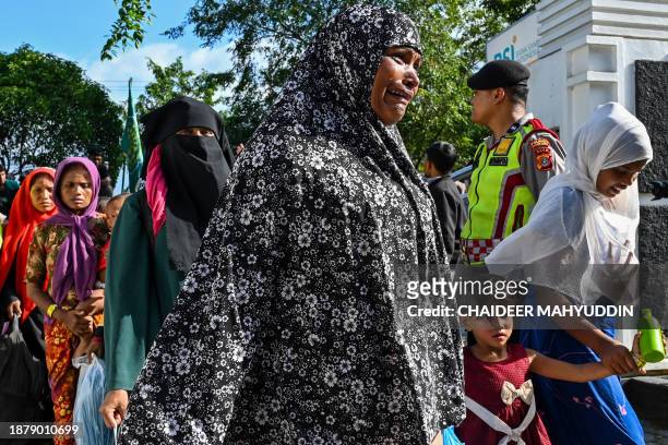 Rohingya refugees enter the compounds of a government building after demonstrating university students forced them to relocate from a previous...