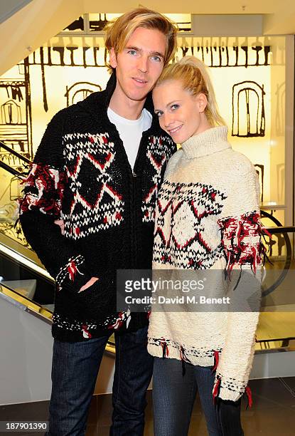 Poppy Delevingne and James Cook attend the Isabel Marant Pour H&M Preview on November 13, 2013 in London, England.
