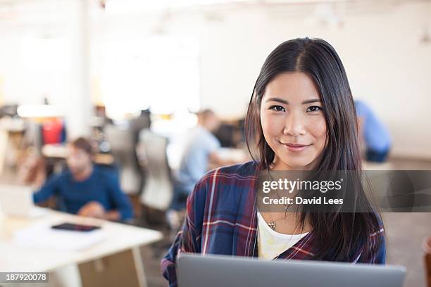 businesswoman using laptop in modern office - incidental people stock pictures, royalty-free photos & images