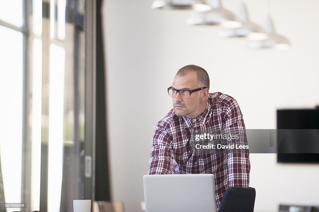 Businessman using laptop in modern office