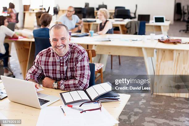 portrait of businessman in busy modern office - receding stock pictures, royalty-free photos & images